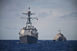 A USS Destroyer and Littoral Combat Ship hunt together in the South Pacific. Taken during a Pacific Deployment in 2014.